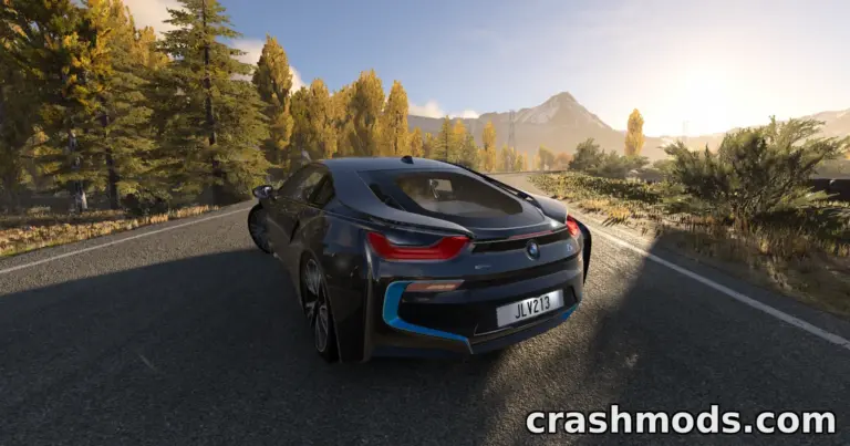 A sleek BMW i8 drives along a scenic road, surrounded by autumn foliage and mountains in the background.