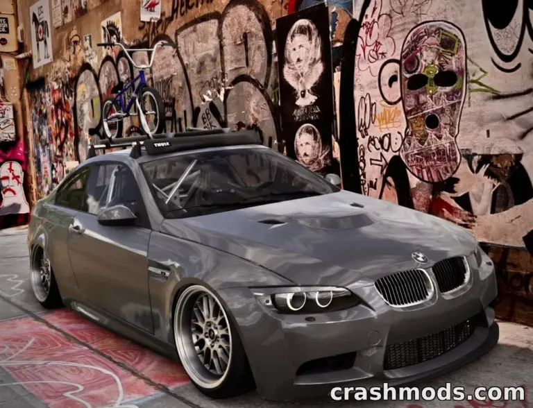 A customized BMW M3 E92 with a sleek gray finish and bike rack, set against a vibrant graffiti wall in BeamNG.drive.