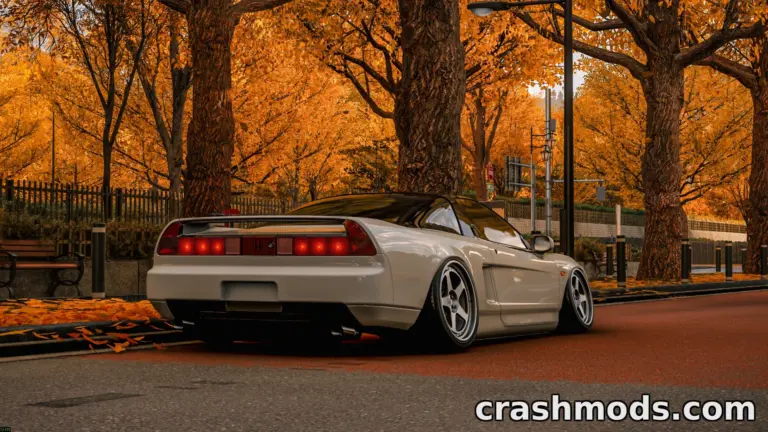 A sleek white Honda NSX parked on a scenic autumn street, surrounded by vibrant orange foliage.