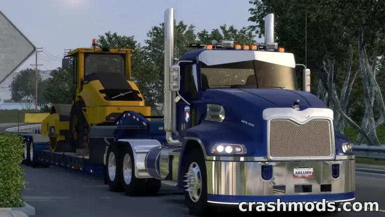 A blue truck hauls a yellow construction vehicle on a flatbed trailer along a scenic road in American Truck Simulator.
