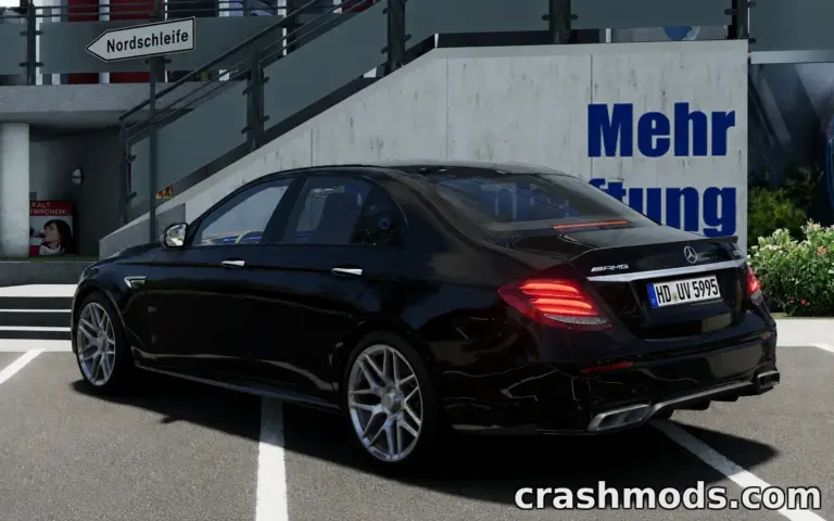 Black Mercedes-Benz AMG W213 parked at a modern building, showcasing sleek design and detailed modding features.