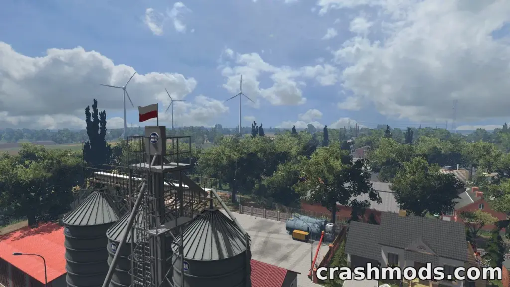 A scenic view of a farm in "Podkarpacie V2 2026," featuring silos, wind turbines, and lush greenery.