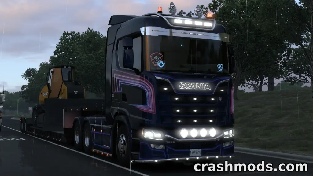 A Scania truck from the Mega Pack Free mod hauls heavy machinery on a rainy road in American Truck Simulator.
