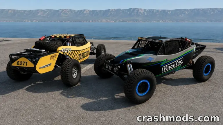 Two modified off-road vehicles, the Trackfab Tomahawk, parked by a scenic waterfront, showcasing vibrant designs.