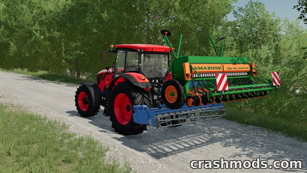 A red tractor pulls the Amazone D8 30 Pack seeder along a dirt path, surrounded by lush greenery.