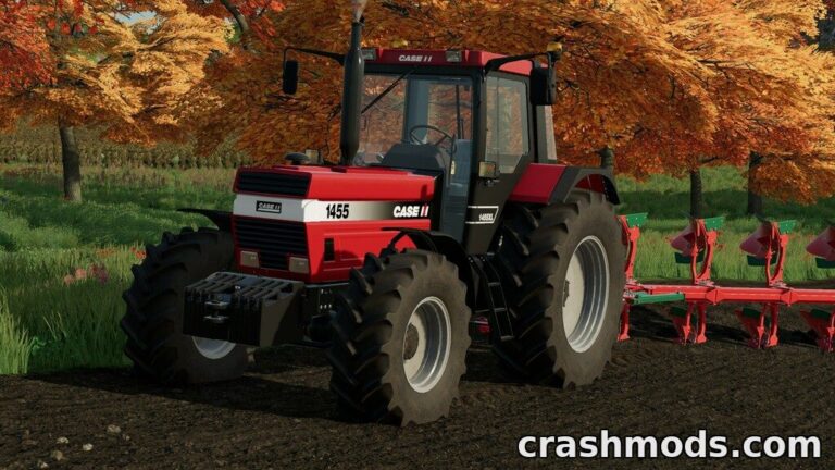 Classic Case IH 1455 XL tractor with vibrant red and black design, ready for plowing in a lush autumn landscape.