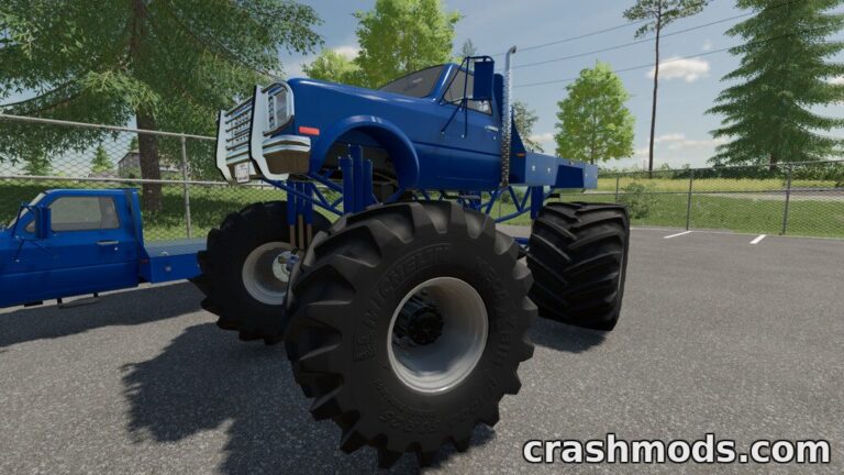 A blue flatbed monster truck with massive tires, showcasing its impressive height and power in Farming Simulator 22.