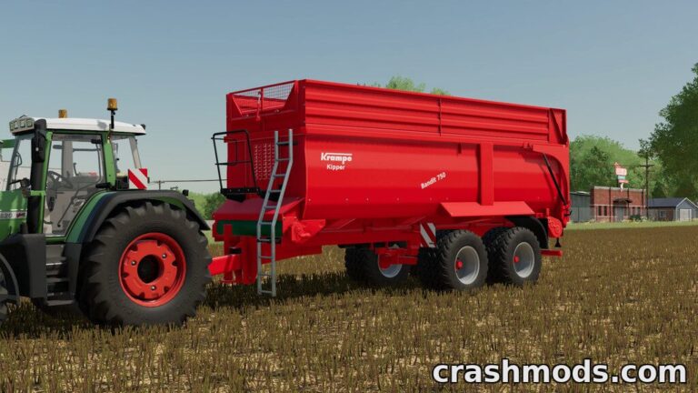 The Krampe Bandit 750 tipper, in vibrant red, is attached to a tractor in a field, ready for farming tasks.