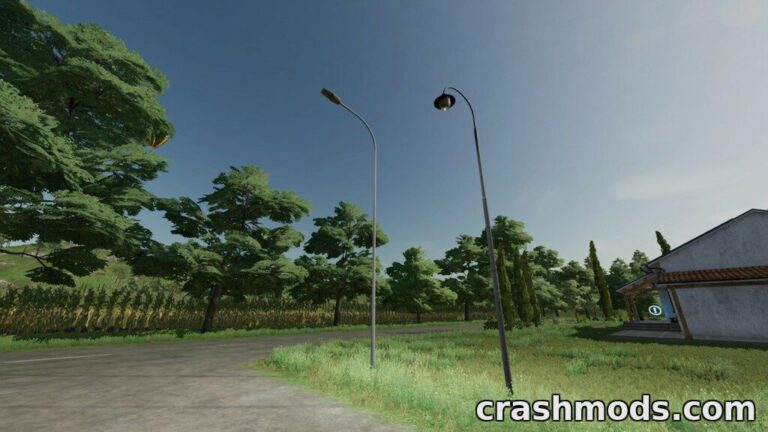 Two placeable light poles stand beside a road, enhancing the landscape in Farming Simulator 22.