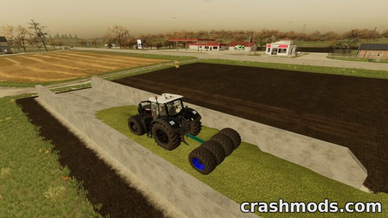 A black tractor equipped with large wheels compacts silage in a farming landscape, showcasing the Lizard Wheel Roller mod.