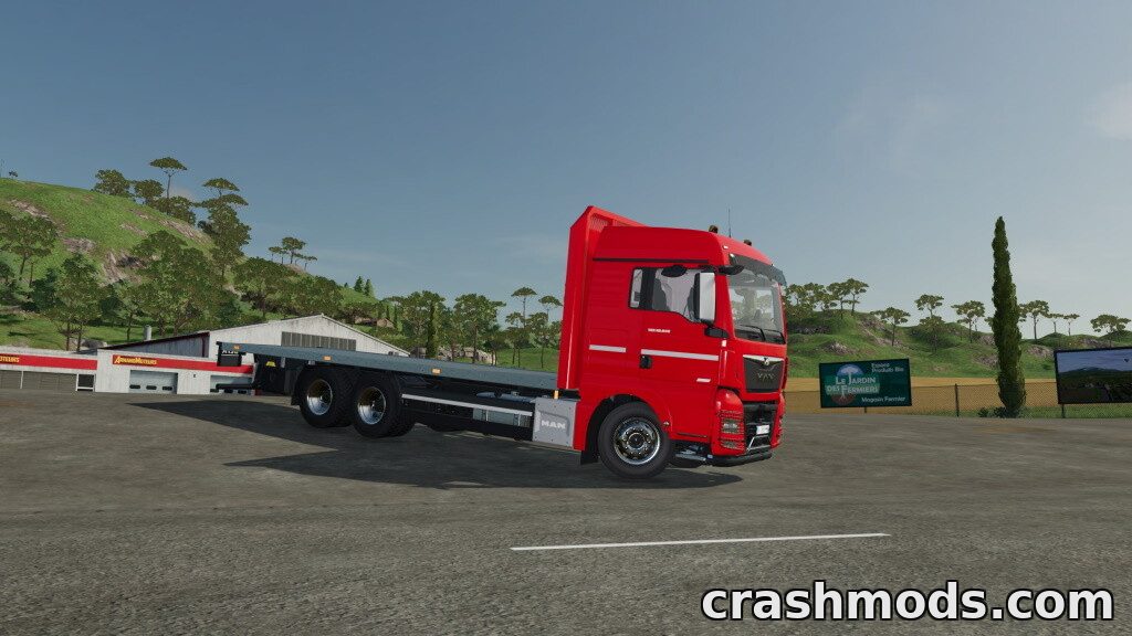 Red MAN TGX 26.640 flatbed truck positioned on a rural road, ready for transporting bales and pallets in Farming Simulator 22.