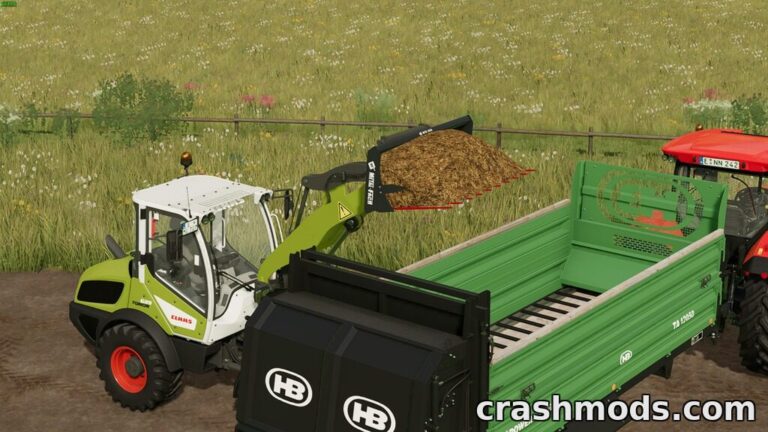 The Claas loader lifts a load of manure with the MetalFach fork, ready to fill the trailer in Farming Simulator 22.