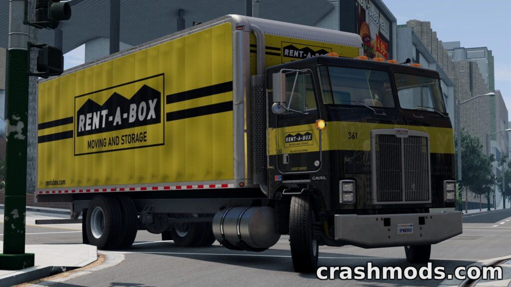 A yellow Rent-A-Box moving truck navigates a city intersection, showcasing its detailed livery in BeamNG.drive.