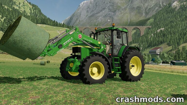 A John Deere tractor equipped with a front loader lifts a round hay bale in a picturesque farming landscape.