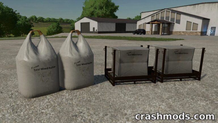 Large bags and pallets of Total Mixed Ration for Farming Simulator 22, set against a rural backdrop.