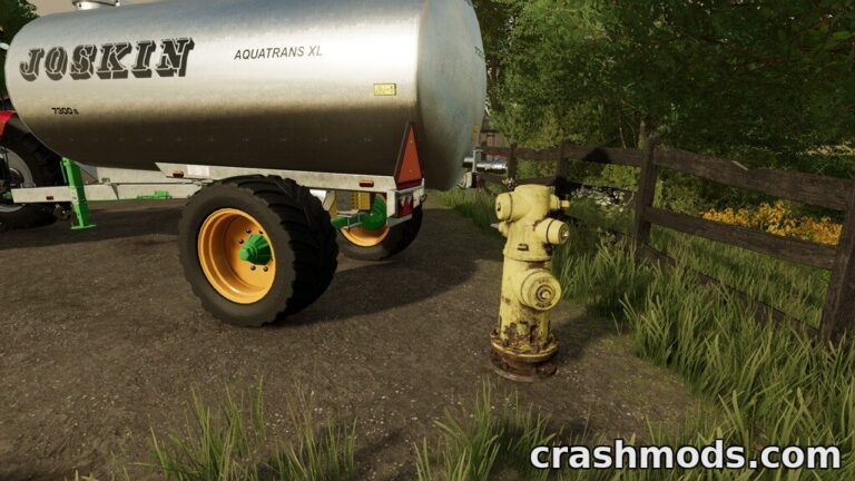 A yellow fire hydrant stands beside a water tank in a lush farming environment, ready for use in Farming Simulator 22.