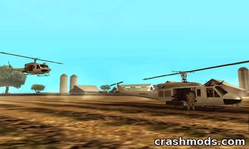 Two detailed Bell UH-1N Twin Huey helicopters land in a rural setting, showcasing their 3D features in GTA San Andreas.