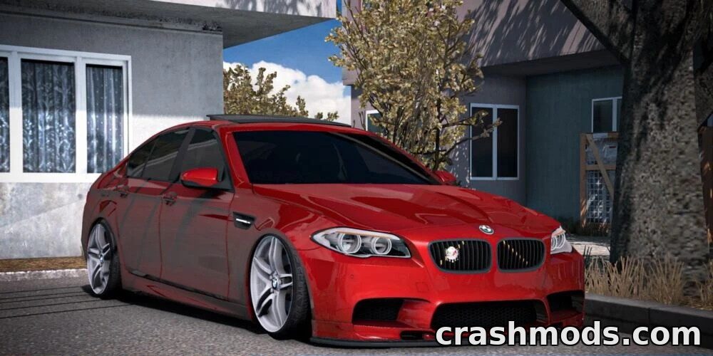 Realistic BMW M5 F10 mod showcased in American Truck Simulator, featuring a sleek red car parked near a building.
