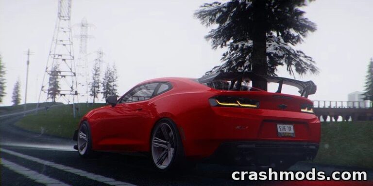 A vibrant red Chevrolet Camaro ZL1 1LE drives along a winding road, showcasing its sleek design and performance.