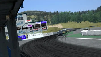 Detailed view of the Ebisu Minami Drift Stadium track in Assetto Corsa, showcasing tire marks and lush surroundings.