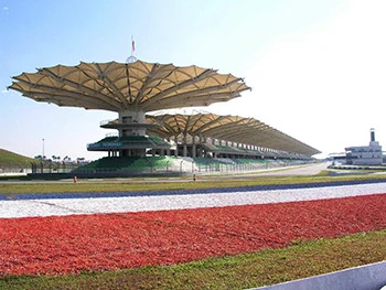 Detailed view of the Sepang International Circuit, showcasing its iconic architecture and vibrant track design.