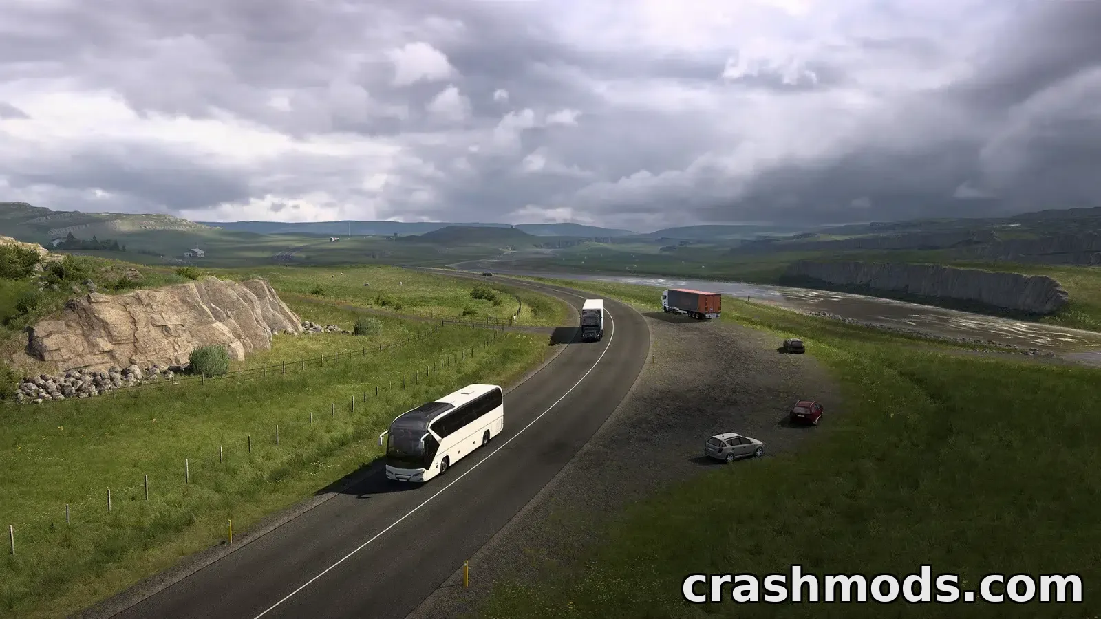 Truck driving along a scenic Icelandic road with mountains and a waterfall in the background